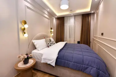 a bedroom with a purple bed and a table at chic ve modern daire taksim meydani in Istanbul