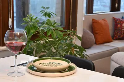 a table with a plate and a glass of wine at chic ve modern daire taksim meydani in Istanbul
