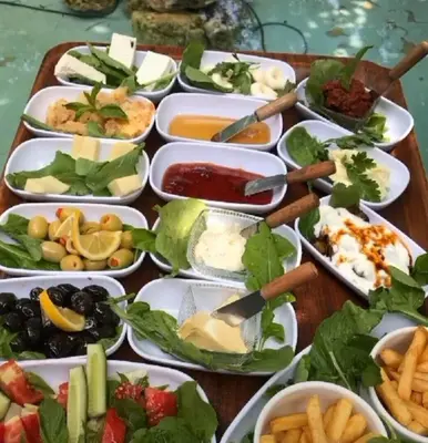 a table with many plates of food on it at Duru Hanım Konağı in Mudanya