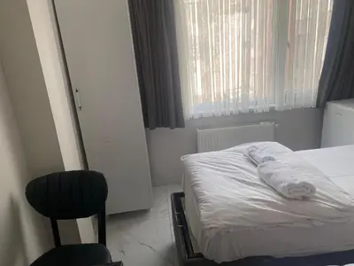 a small bedroom with a bed and a chair at lastbest hotel in Istanbul