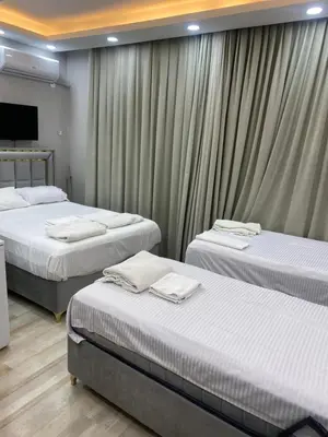 three beds in a room with curtains at lastbest hotel in Istanbul