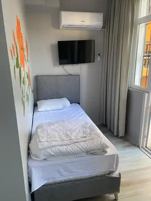 a bedroom with two beds and a flat screen tv at lastbest hotel in Istanbul