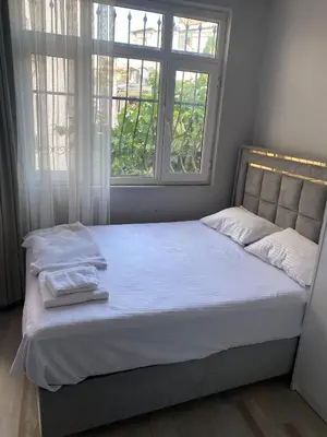 a bed in a room with a large window at lastbest hotel in Istanbul