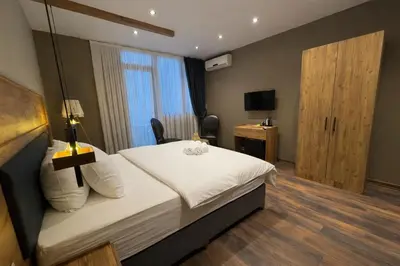 a hotel room with a bed and a television at Goga Otel in Sarıyer