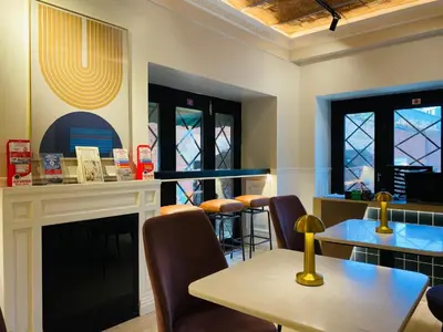 a restaurant with a table and chairs and a fireplace at Pera Standard Rooms in Istanbul