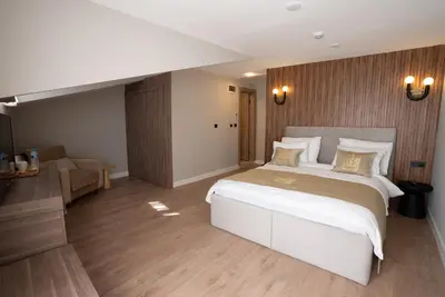 a bedroom with a large white bed and a couch at Kemer City Hotel İstanbul Airport in Kemerburgaz
