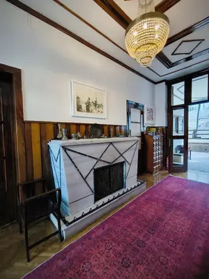 a living room with a fireplace and a chandelier at Palm Villa Büyükada in Istanbul
