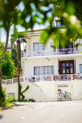 a building with a bike parked in front of it at Palm Villa Büyükada in Istanbul