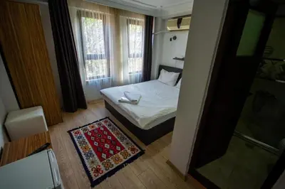 a small bedroom with a bed and a window at Altun Life City in Istanbul