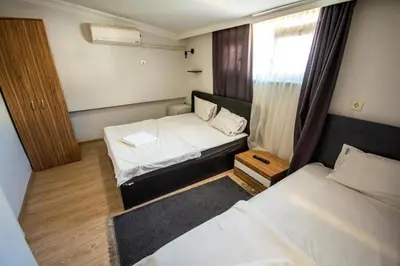a small room with two beds and a window at Altun Life City in Istanbul