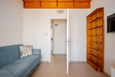 a living room with a blue couch and a door at Marmara Yali Evi in Marmara