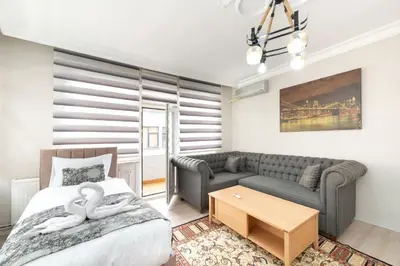 a bedroom with a bed and a couch at MARMARA DREAM APARt in Istanbul