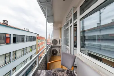 a chair sitting on a balcony next to a window at MARMARA DREAM APARt in Istanbul