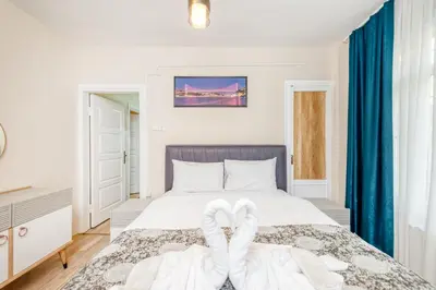 a bedroom with a bed with two white towels on it at MARMARA DREAM APARt in Istanbul