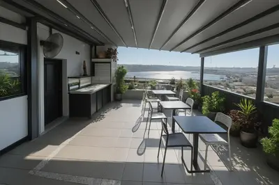 a balcony of a restaurant with tables and chairs at Big Urban Taksim Terrace Stay in Istanbul