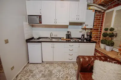 a kitchen with white cabinets and a sink at Taksim Nil Suite in Istanbul