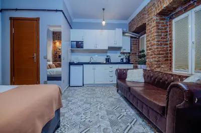 a living room with a couch and a brick wall at Taksim Nil Suite in Istanbul