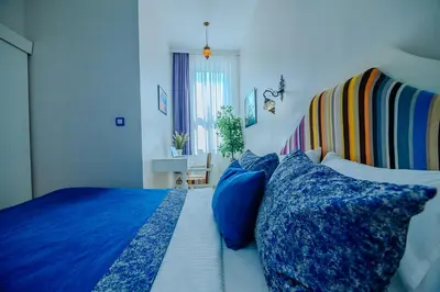 a bedroom with a bed with blue pillows at Taksim Nil Suite in Istanbul