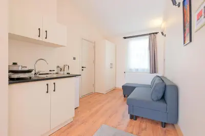 a kitchen with a blue chair and a sink at Casa Nozze in Istanbul