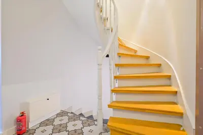 a staircase in a house with a red fire extinguisher at Casa Nozze in Istanbul