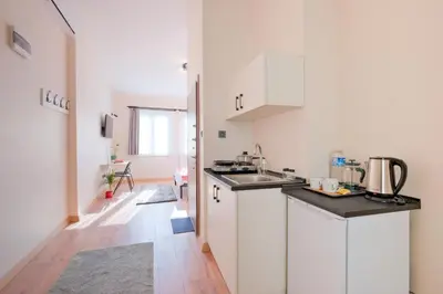 a white kitchen with a sink and a counter at Casa Nozze in Istanbul