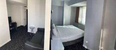 two pictures of a bedroom with a bed and a chair at Anı Park Hotel in Pendik