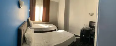 a hotel room with two beds and a window at Anı Park Hotel in Pendik