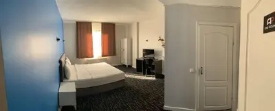 a hotel room with a bed and a bathroom at Anı Park Hotel in Pendik