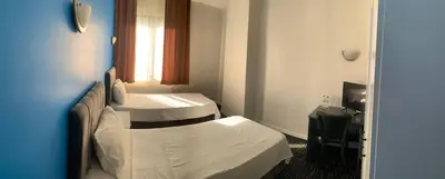 a hotel room with two beds and a window at Anı Park Hotel in Pendik