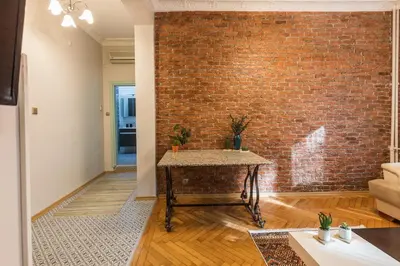 a brick wall in a living room with a table at Stylish 1BR with Prime Location and Bold Design in Istanbul