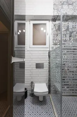 a bathroom with two toilets and a window at Stylish 1BR with Prime Location and Bold Design in Istanbul