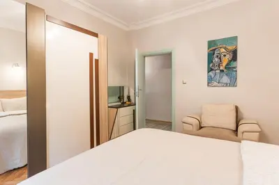 a bedroom with a white bed and a chair at Stylish 1BR with Prime Location and Bold Design in Istanbul