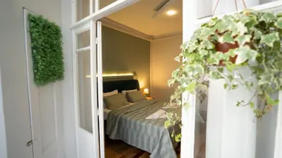 a bedroom with a bed in a room with a window at Taksim Green Flat Apartment in Istanbul