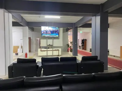 a room with black chairs and a flat screen tv at Kocaeli Konaklama in Izmit