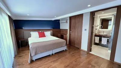 a bedroom with a bed and a bathroom with a sink at Snog Rooms & Suites in Istanbul