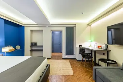 a bedroom with a bed and a desk and a table at Snog Rooms & Suites in Istanbul