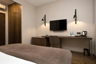 a hotel room with a desk and a television at Snog Rooms & Suites in Istanbul