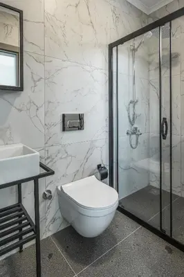 a bathroom with a toilet and a shower and a sink at New Balturk Nature Villas in Sapanca