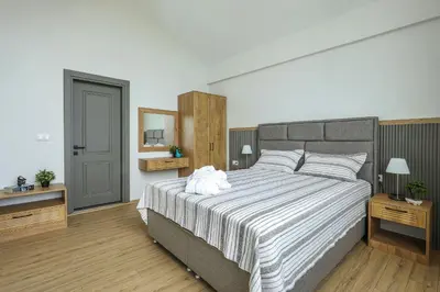a bedroom with a large bed with a white stuffed animal on it at New Balturk Nature Villas in Sapanca