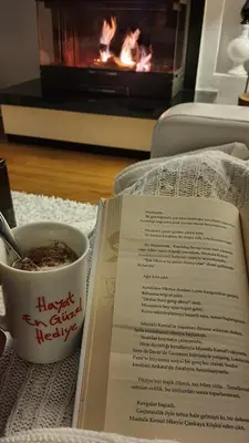 a book and a cup of coffee and a cup of tea at Cadde Sapanca Sıcak Havuzlu Geniş Bahçeli in Sapanca