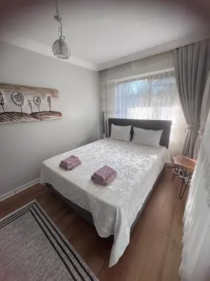 a bedroom with a bed with two towels on it at Cadde Sapanca Sıcak Havuzlu Geniş Bahçeli in Sapanca