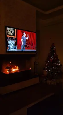 a living room with a christmas tree and a tv screen at Cadde Sapanca Sıcak Havuzlu Geniş Bahçeli in Sapanca