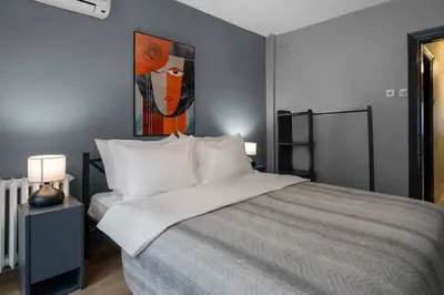 a bedroom with a bed with a painting on the wall at Cozy and Modern 3BR with Private Patio in Beşiktaş in Istanbul