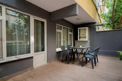a porch with a table and chairs on a patio at Cozy and Modern 3BR with Private Patio in Beşiktaş in Istanbul