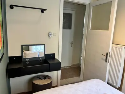 a bedroom with a vanity with a mirror and a bed at Elegant and Cozy 2BR with Balcony near Taksim in Istanbul