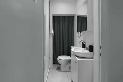 a white bathroom with a toilet and a sink at Elegant and Cozy 2BR with Balcony near Taksim in Istanbul