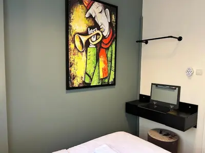 a bedroom with a painting on the wall and a desk at Elegant and Cozy 2BR with Balcony near Taksim in Istanbul