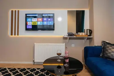 a living room with a blue couch and a table at Lina Suit Hotel in Istanbul