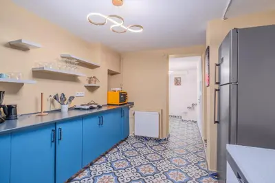 a kitchen with blue cabinets and a tile floor at Cozy Private Home in Kadıköy – Near Coast Ferry in Istanbul