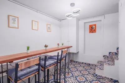 a room with a bar with blue chairs at Cozy Private Home in Kadıköy – Near Coast Ferry in Istanbul